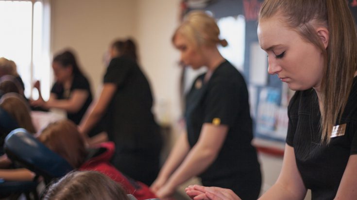 massage therapy students giving chair massages