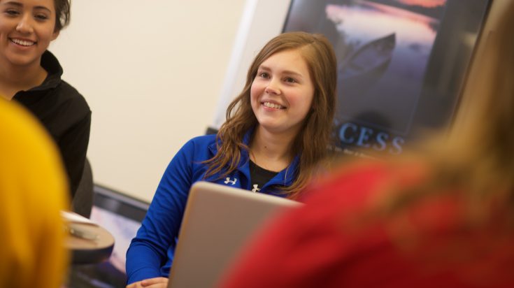 A group of four female business students having a discussion
