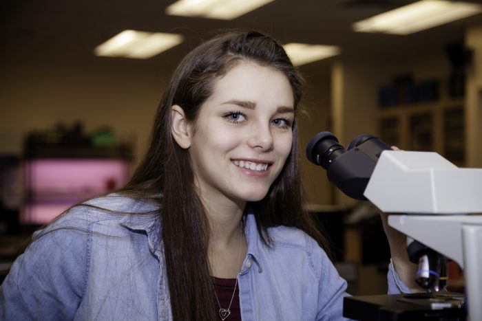 Girl smiling in a science class