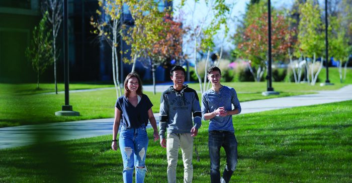 three students smiling