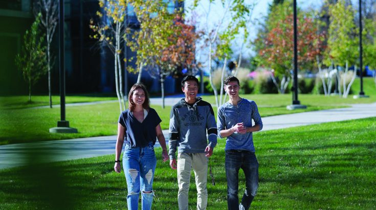 three students smiling
