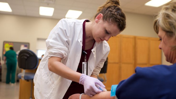 Phlebotomy student practicing