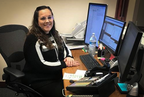 Legal assistant graduate at desk