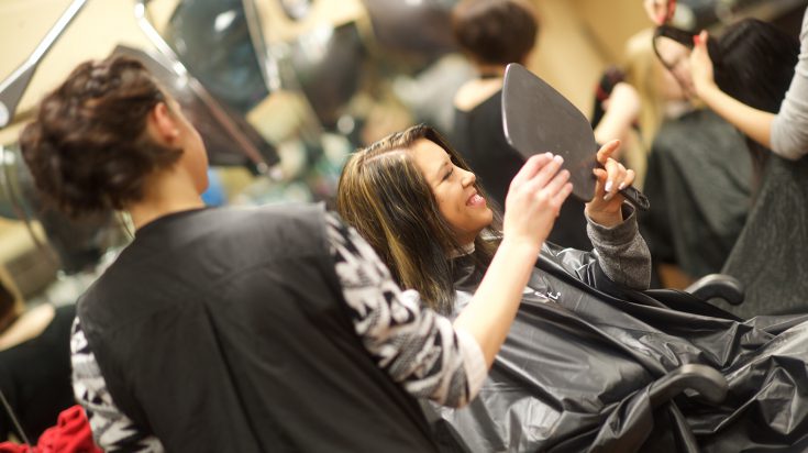 Cosmetology student with client
