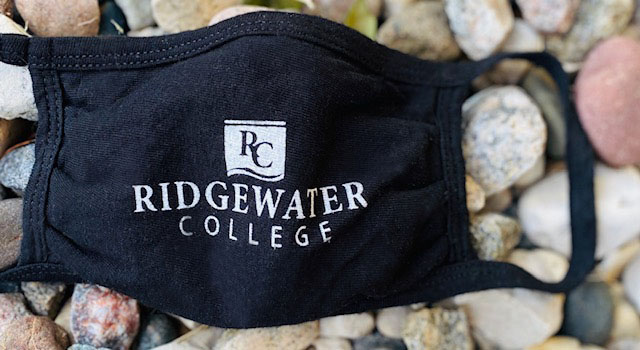 Photo of a face mask with ridgewater logo lying on rocks