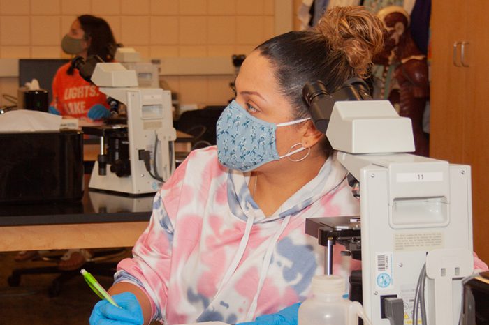 science student in lab with mask on