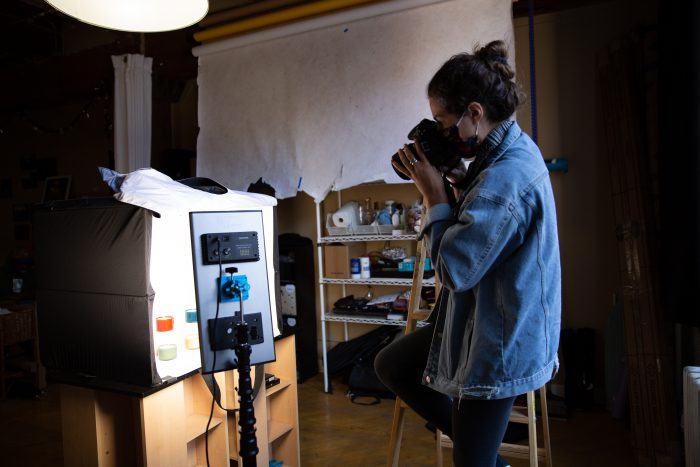 Photo of a student showing off a design on her computer