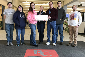 Photo of the honor society receiving the check