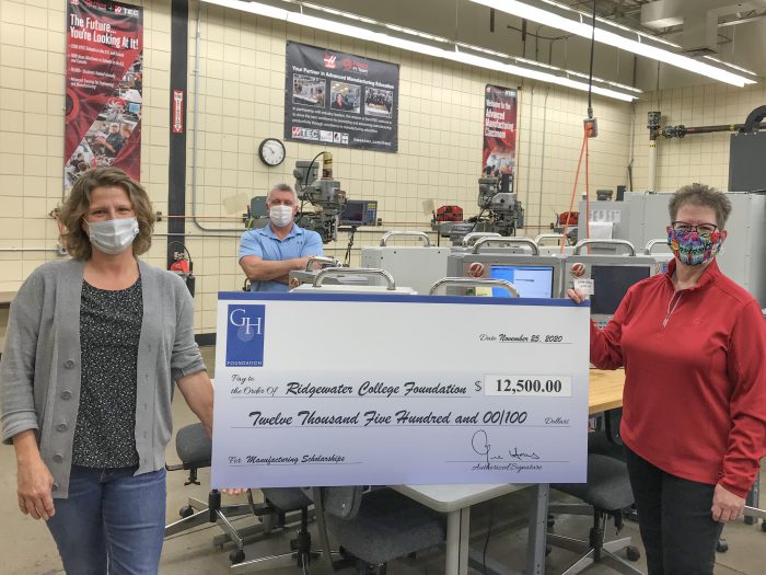 Photo of the Machine tool faculty holding a large check from the
